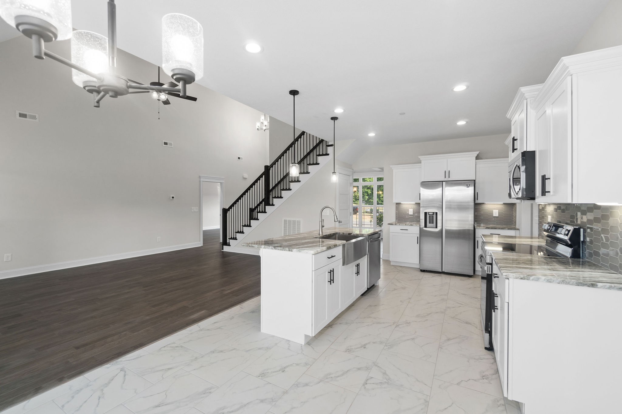 6507 Blacksmith Drive Pleasant View, TN 37146 - Photo 4 of 5 a kitchen with stainless steel appliances kitchen island a stove a refrigerator and a sink