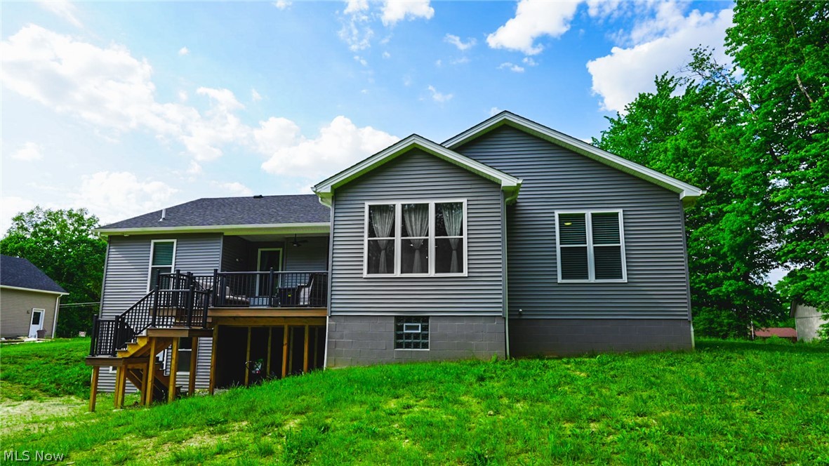 4211 Burgett Road Canfield, OH 44406 - Photo 15 of 17 Back of property with a deck and a lawn