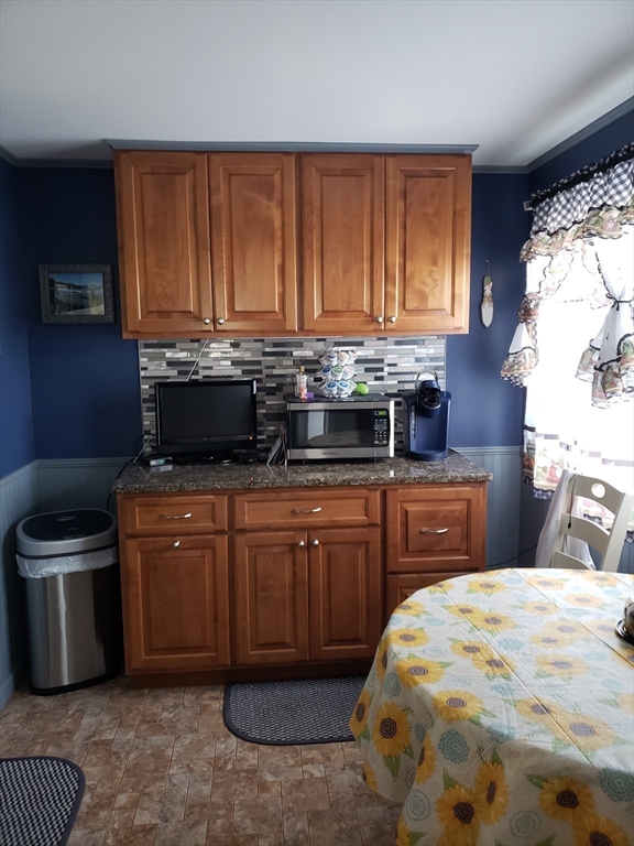 76 Canterbury Road Springfield, MA 01118 - Photo 8 of 27 a kitchen with a stove a sink and a microwave