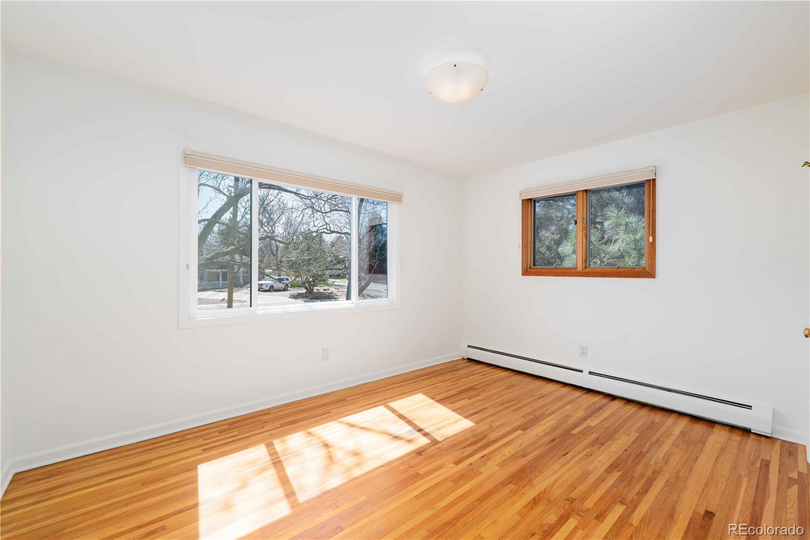 3815 East Easter Place Centennial, CO 80122 - Photo 11 of 35 a view of an empty room with wooden floor and a window