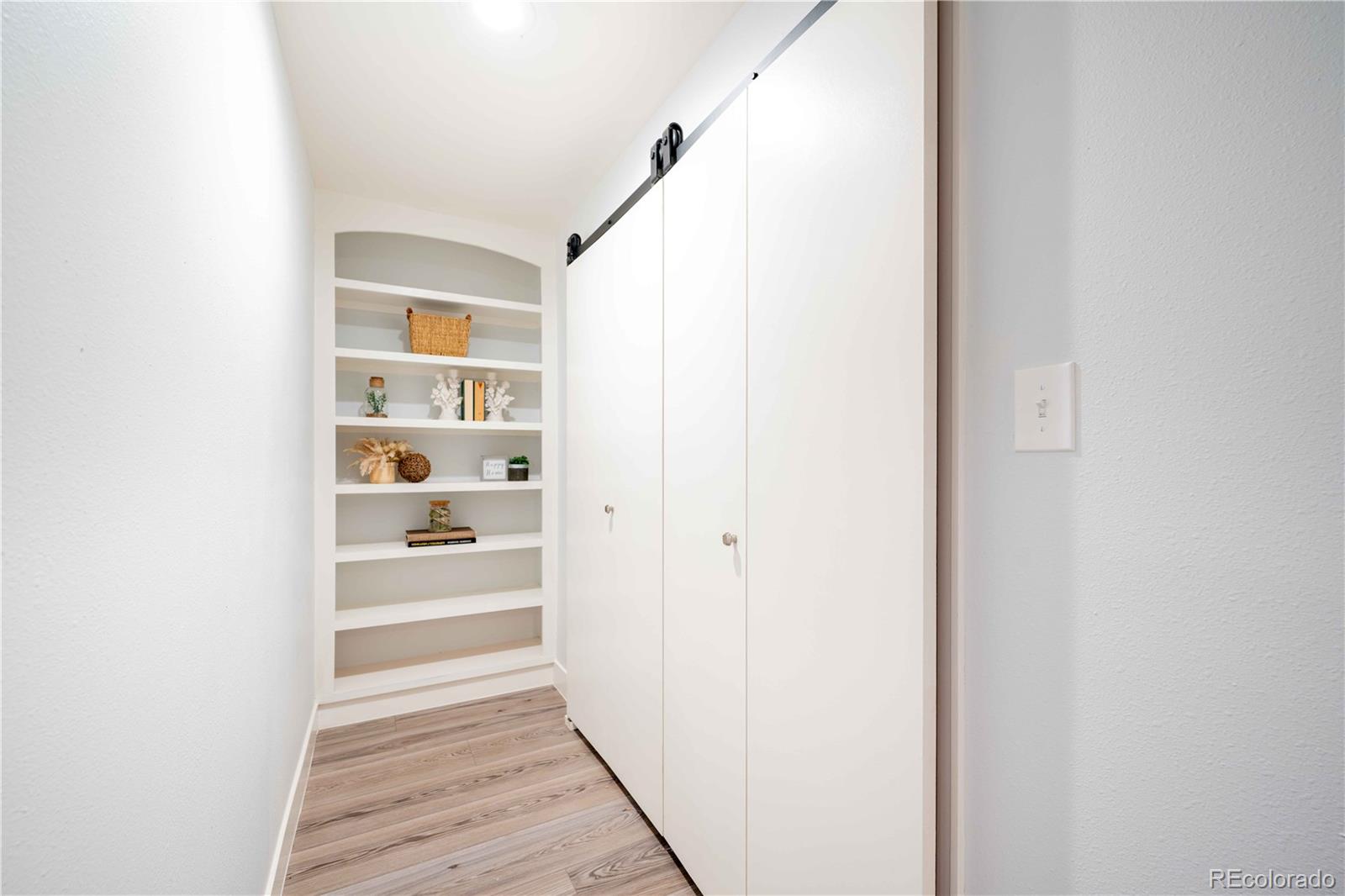 3815 East Easter Place Centennial, CO 80122 - Photo 17 of 35 a view of a hallway with wooden floor and entryway