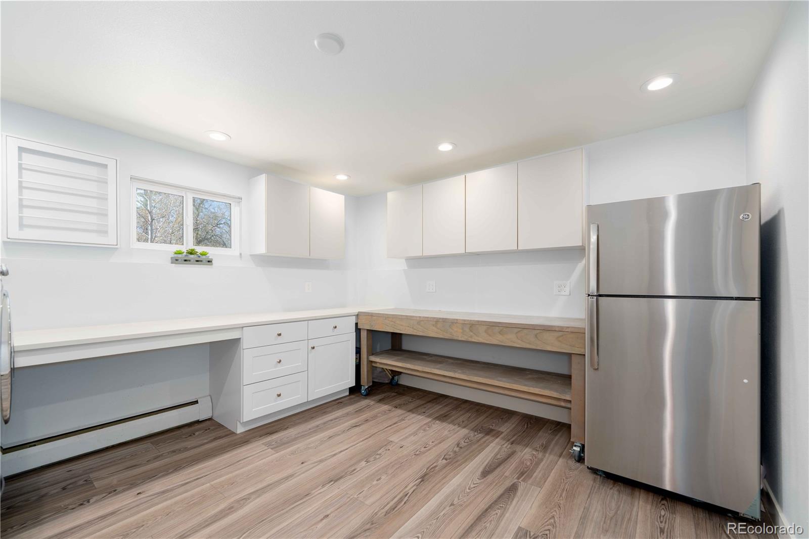 3815 East Easter Place Centennial, CO 80122 - Photo 19 of 35 a kitchen with white cabinets and stainless steel appliances