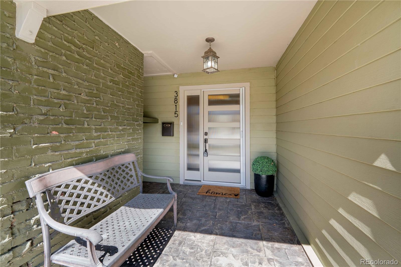 3815 East Easter Place Centennial, CO 80122 - Photo 2 of 35 a view of wooden door and outdoor seating