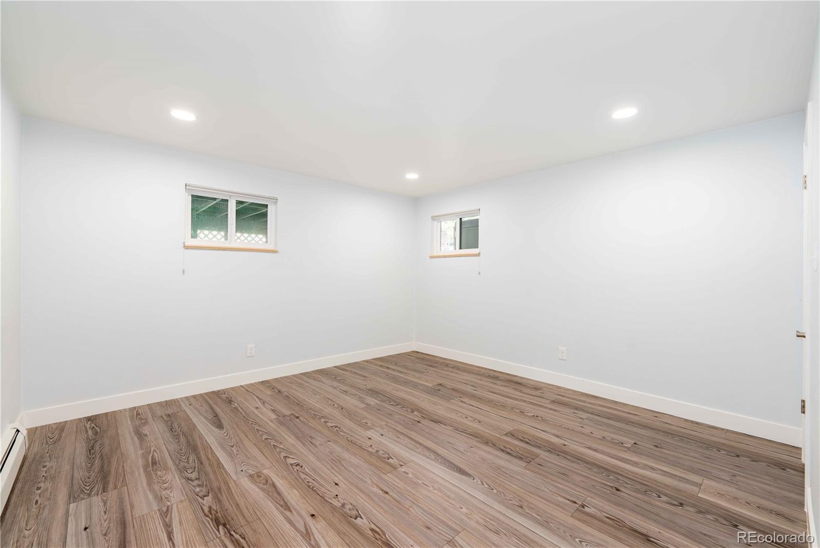 3815 East Easter Place Centennial, CO 80122 - Photo 22 of 35 an empty room with wooden floor and windows