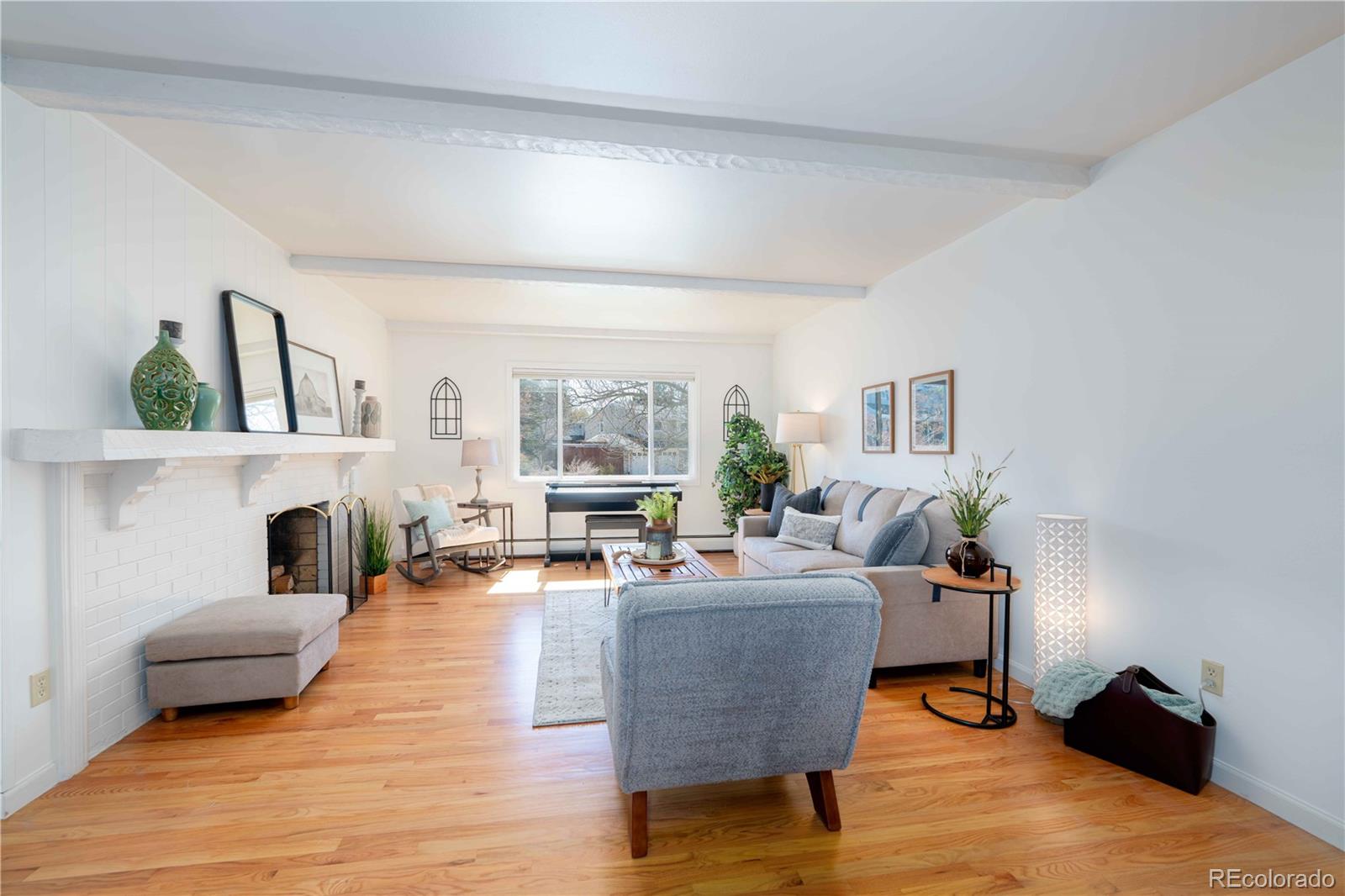 3815 East Easter Place Centennial, CO 80122 - Photo 3 of 35 a living room with furniture a fireplace and a potted plant
