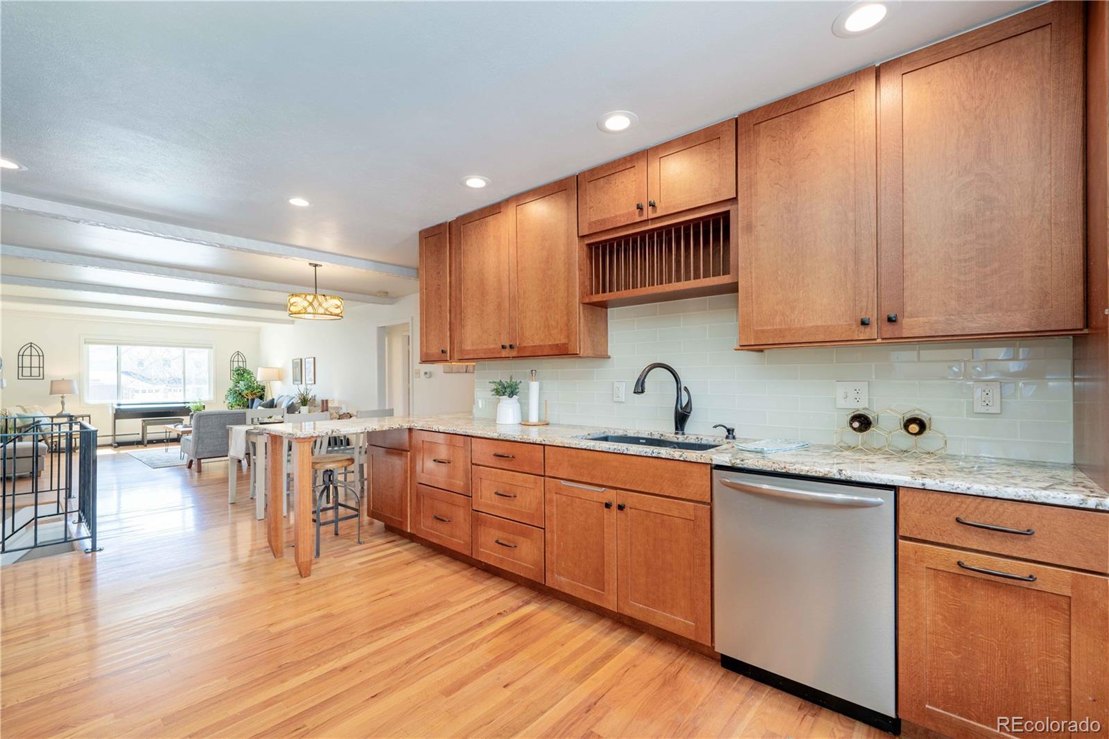 3815 East Easter Place Centennial, CO 80122 - Photo 8 of 35 a kitchen with a sink cabinets and wooden floor