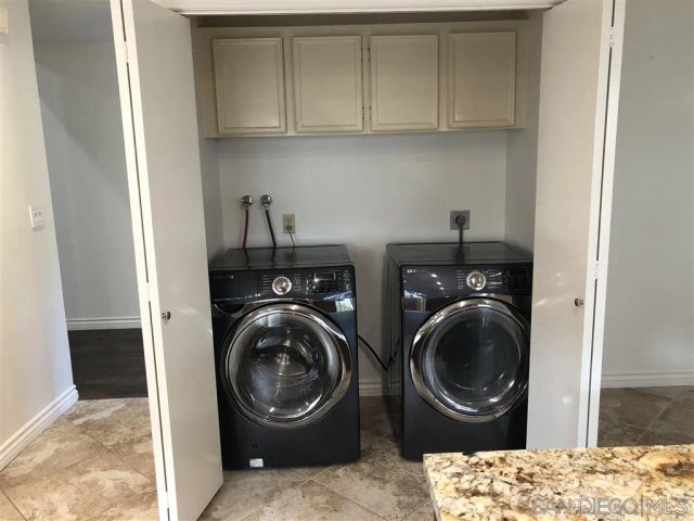 a utility room with sink dryer and washer