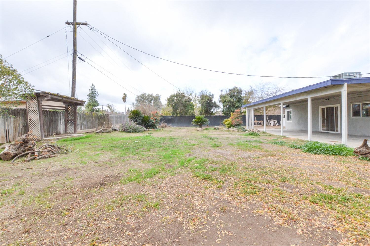 4613 West Andrews Fresno, CA 93722 - Photo 18 of 20 a backyard of a house with seating space