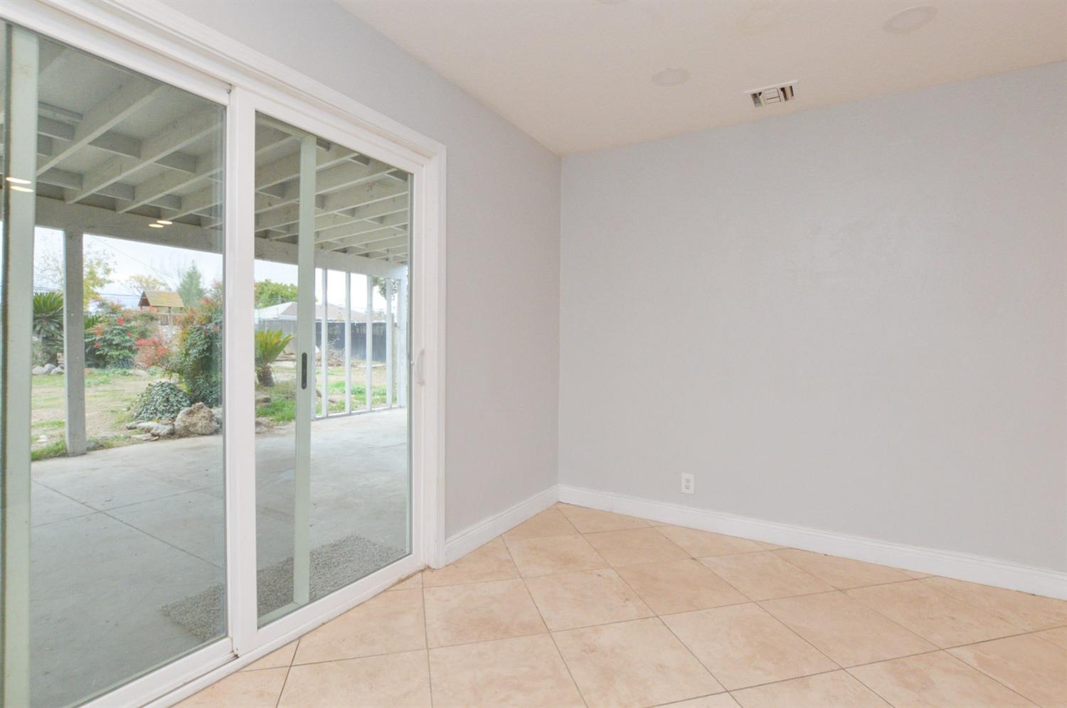 4613 West Andrews Fresno, CA 93722 - Photo 9 of 20 a view of empty room with sliding glass door