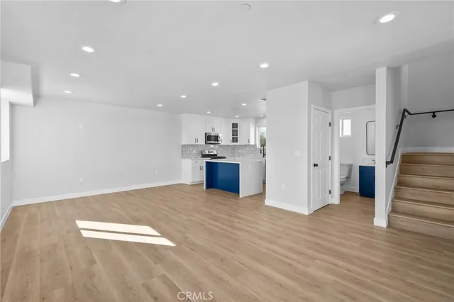 a view of kitchen with wooden floor and electronic appliances