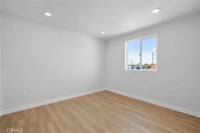 a view of room with wooden floor and fan
