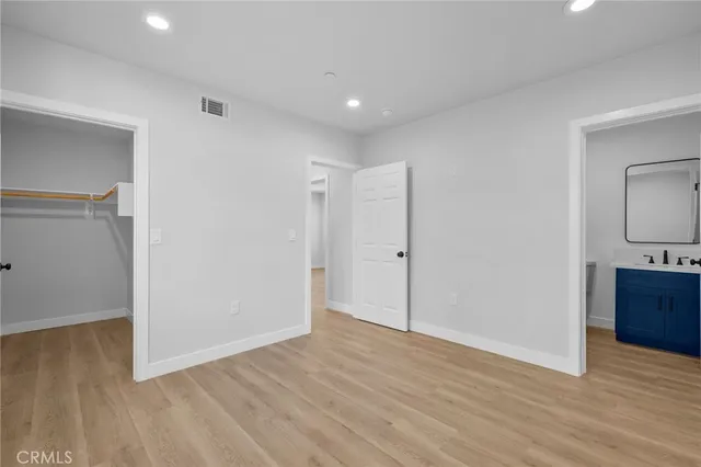 a view of hallway with wooden floor