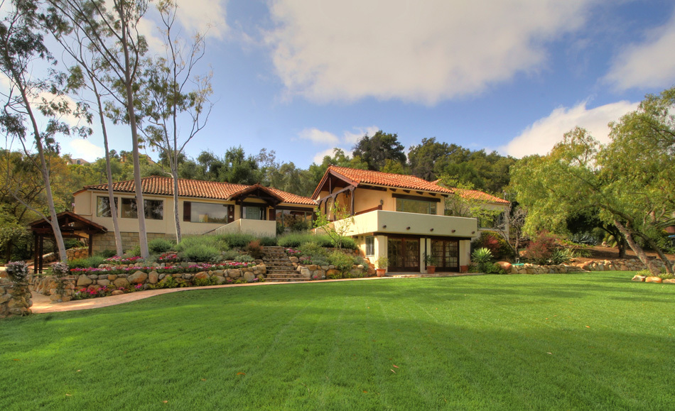 1331 Tunnel Road Santa Barbara, CA 93105 - Photo 1 of 22 a front view of a house with a garden and trees