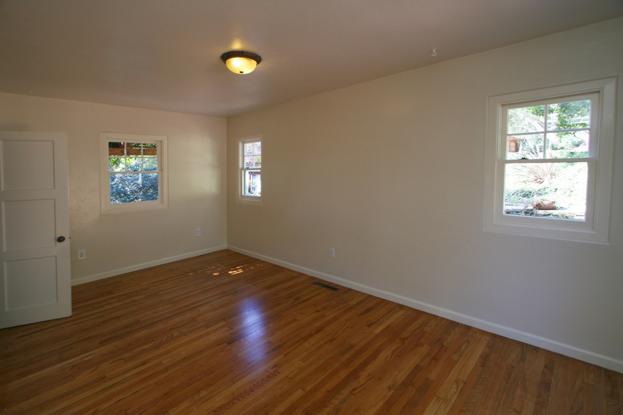 1331 Tunnel Road Santa Barbara, CA 93105 - Photo 15 of 22 a view of an empty room with wooden floor and a window