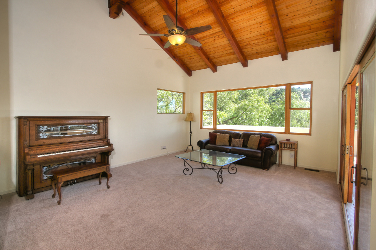 1331 Tunnel Road Santa Barbara, CA 93105 - Photo 17 of 22 a living room with furniture a flat screen tv and a window