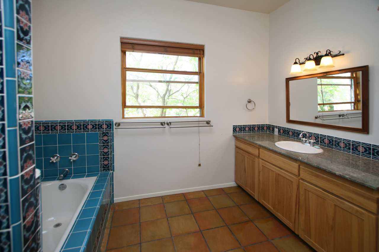 1331 Tunnel Road Santa Barbara, CA 93105 - Photo 21 of 22 a bathroom with a tub sink and mirror