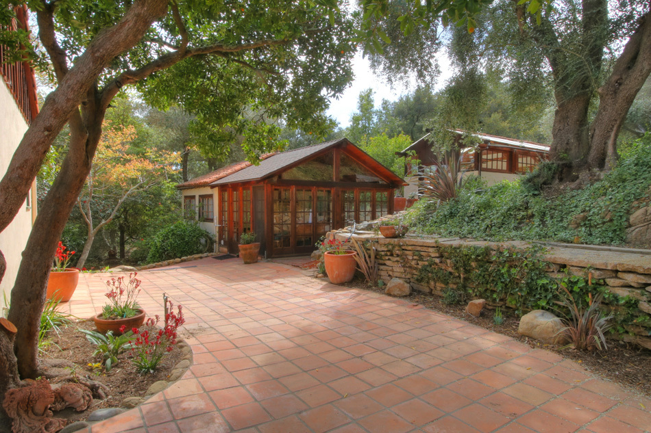 1331 Tunnel Road Santa Barbara, CA 93105 - Photo 4 of 22 a view of a house with a small yard and a large tree