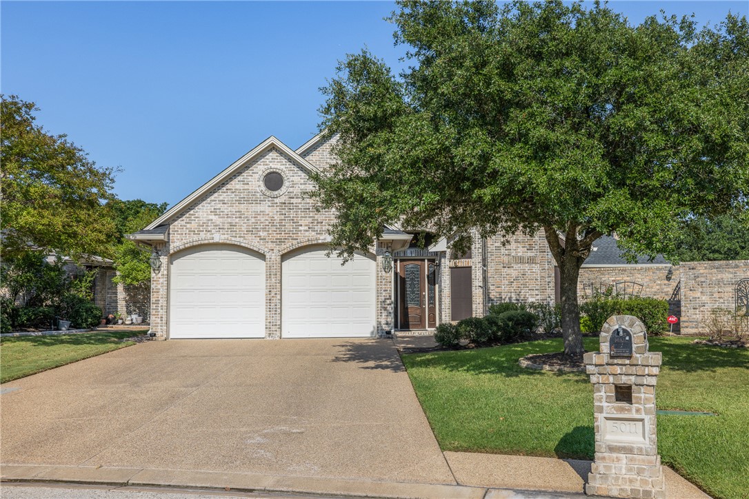 5011 Fairfield Court Bryan, TX 77802 - Photo 1 of 46 a front view of a house with a yard