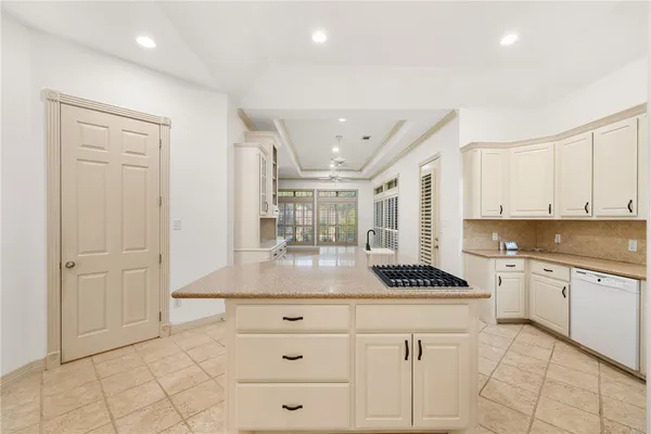 a kitchen with a refrigerator and white cabinets
