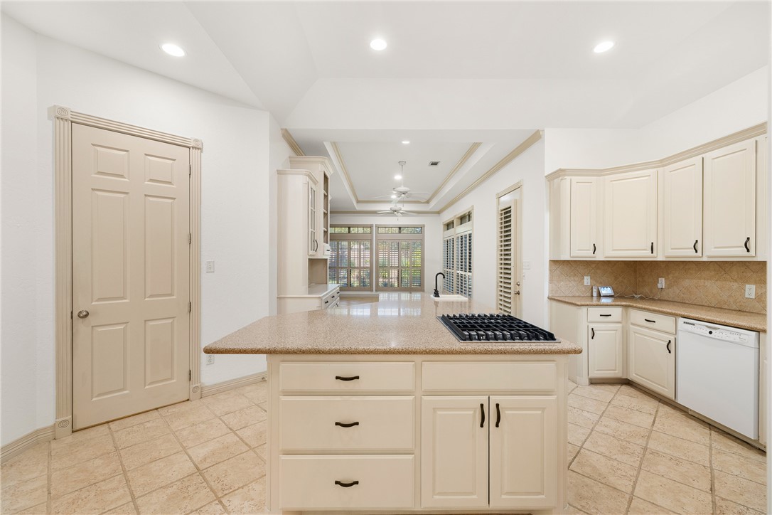 5011 Fairfield Court Bryan, TX 77802 - Photo 11 of 46 a kitchen with a refrigerator and white cabinets