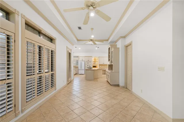 a view of a hallway with wooden floor and a kitchen