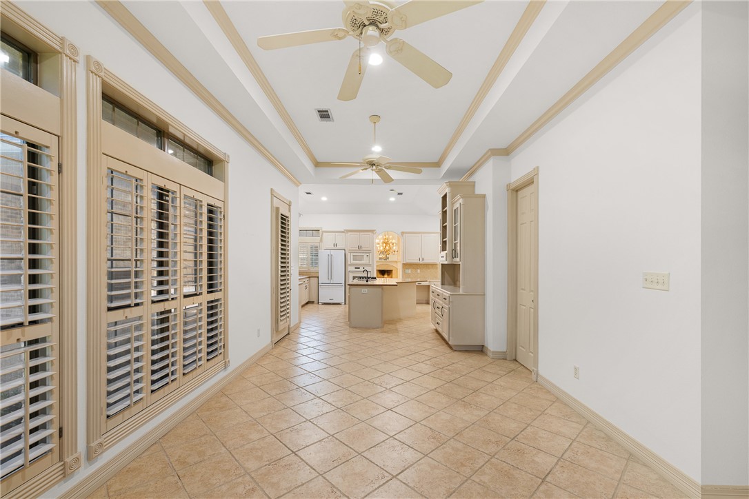 5011 Fairfield Court Bryan, TX 77802 - Photo 15 of 46 a view of a hallway with wooden floor and a kitchen