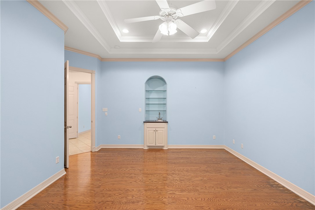 5011 Fairfield Court Bryan, TX 77802 - Photo 23 of 46 an empty room with wooden floor cabinet and windows