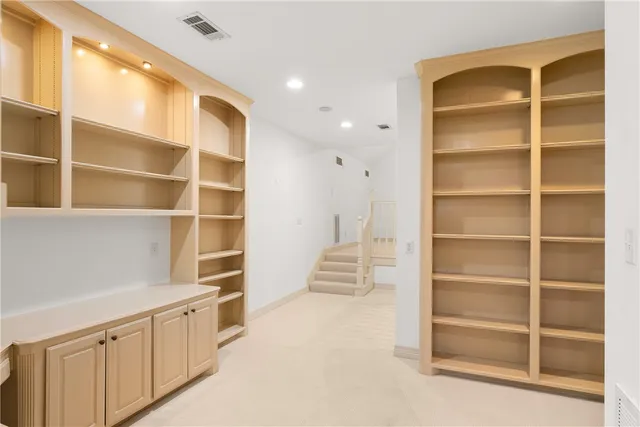 an empty room with a ceiling fan and a window
