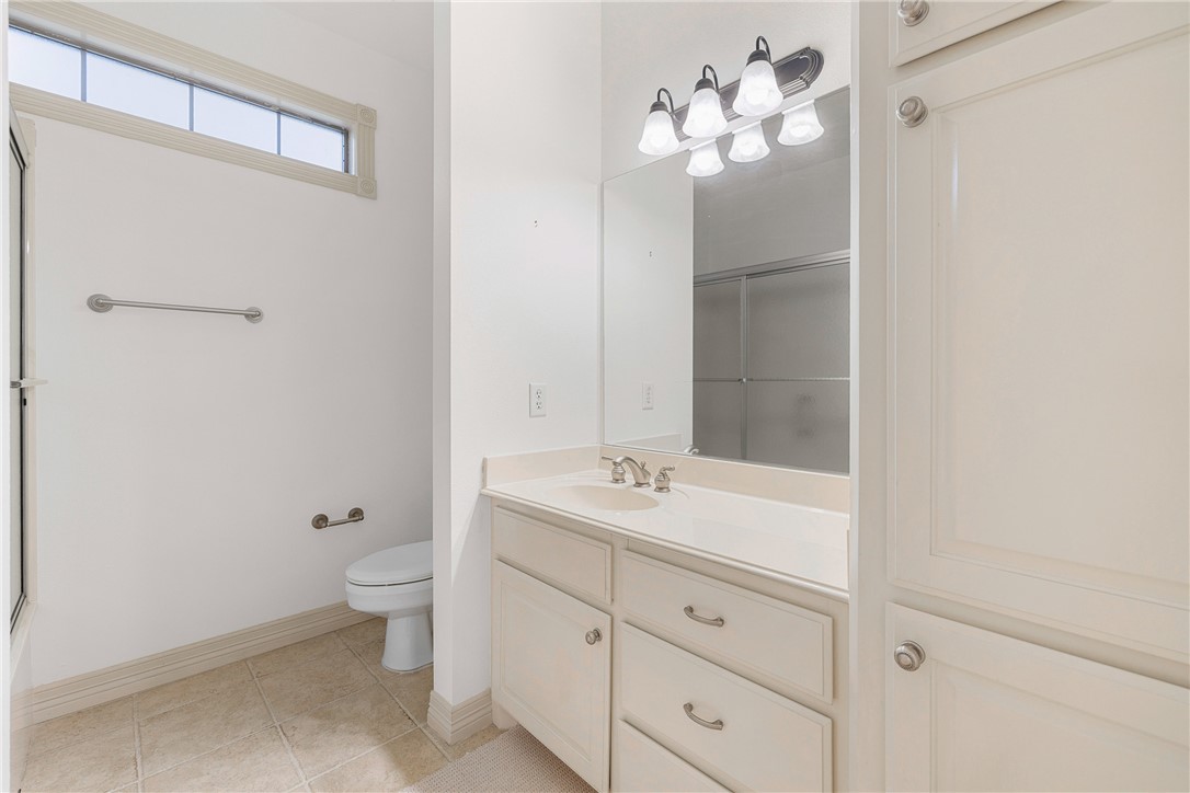 5011 Fairfield Court Bryan, TX 77802 - Photo 34 of 46 a bathroom with a toilet sink and mirror