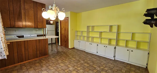 a kitchen with cabinets and wooden floor