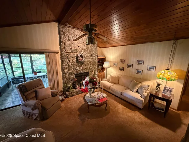 a living room with furniture a fireplace and a table