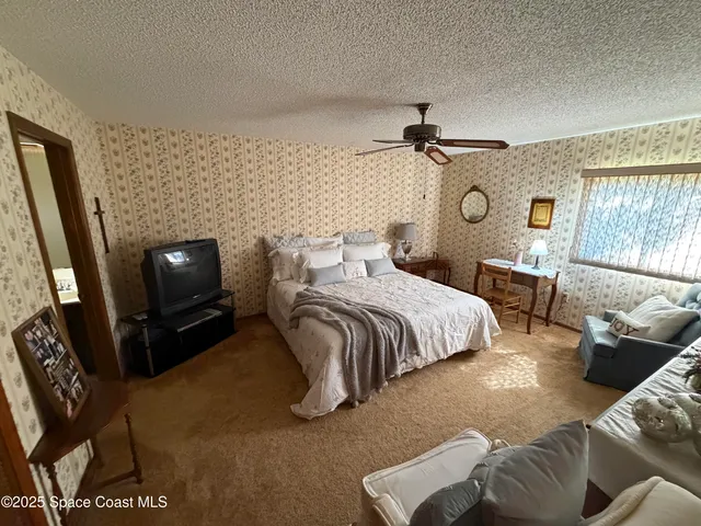 a bedroom with a bed and a television