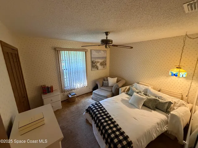 a bedroom with a bed and a couch