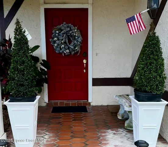 with a potted plant sitting in front of a door