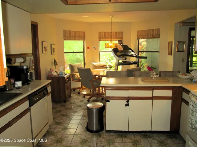 a kitchen with a sink appliances and cabinets