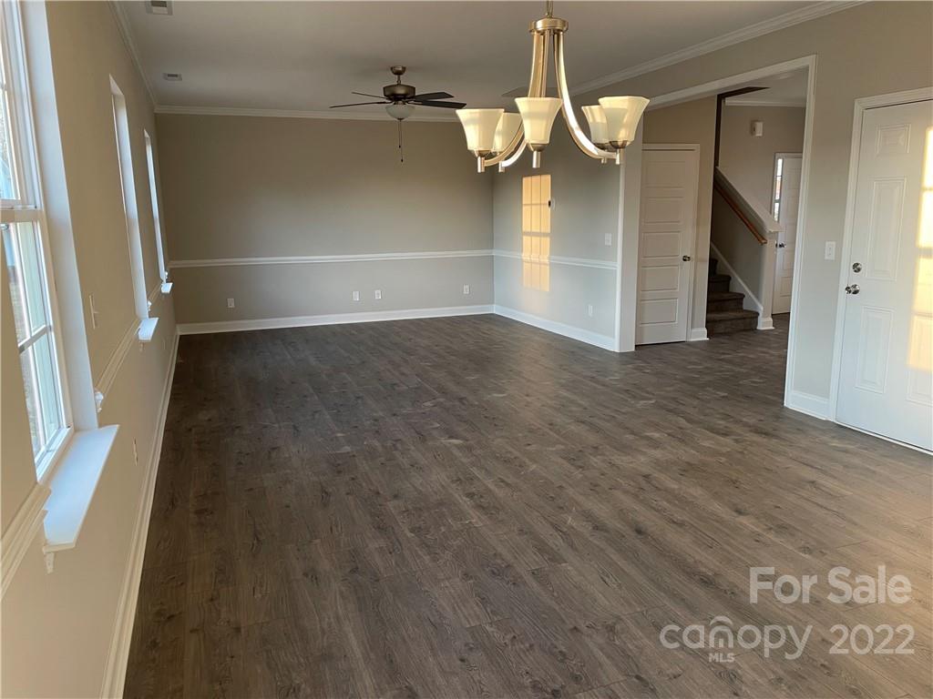4025 Pigg Mattox Road Monroe, NC 28112 - Photo 17 of 18 a view of a room with wooden floor and staircase