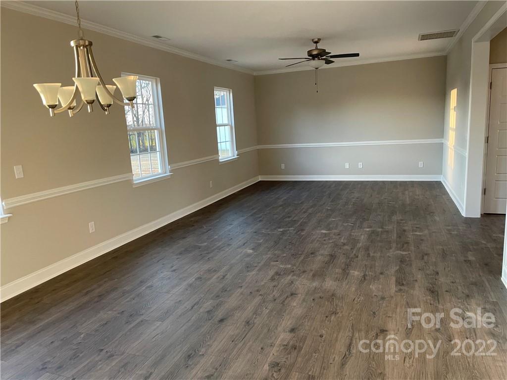 4025 Pigg Mattox Road Monroe, NC 28112 - Photo 3 of 18 wooden floor in an empty room with a window