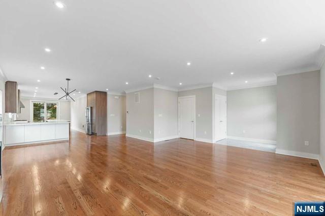 211 Warwick Avenue, Unit 1 Fort Lee, NJ 07024 - Photo 11 of 43 a view of an empty room with kitchen view and a window