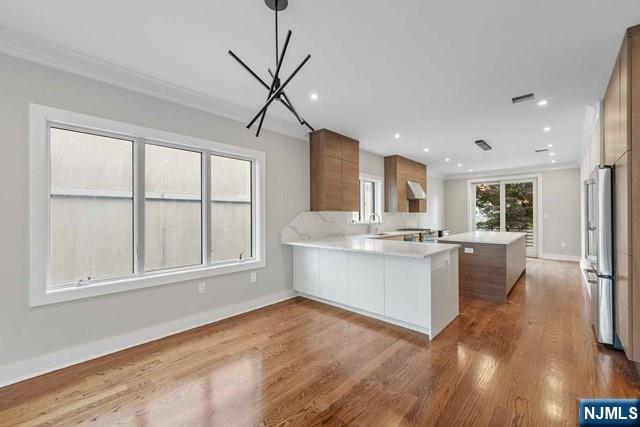 211 Warwick Avenue, Unit 1 Fort Lee, NJ 07024 - Photo 12 of 43 a large white kitchen with a large window appliances and cabinets