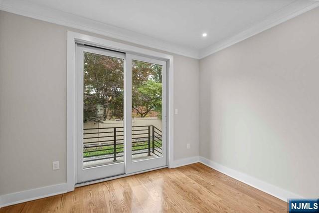 211 Warwick Avenue, Unit 1 Fort Lee, NJ 07024 - Photo 16 of 43 an empty room with wooden floor and windows
