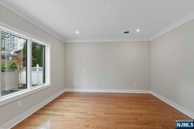 211 Warwick Avenue, Unit 1 Fort Lee, NJ 07024 - Photo 18 of 43 a view of empty room with wooden floor and fan