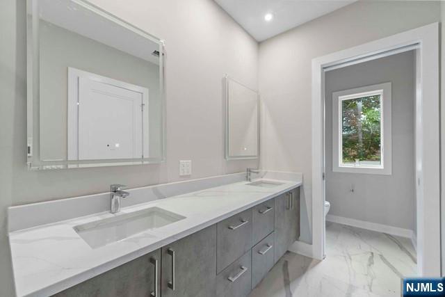 211 Warwick Avenue, Unit 1 Fort Lee, NJ 07024 - Photo 21 of 43 a bathroom with a sink and a vanity