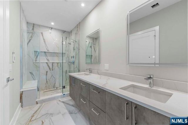 211 Warwick Avenue, Unit 1 Fort Lee, NJ 07024 - Photo 22 of 43 a bathroom with a double vanity sink mirror and shower