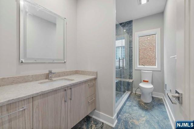 211 Warwick Avenue, Unit 1 Fort Lee, NJ 07024 - Photo 24 of 43 a bathroom with a toilet sink and mirror