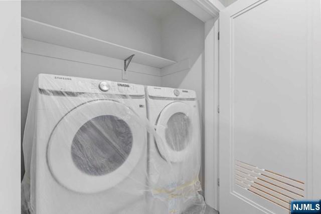 211 Warwick Avenue, Unit 1 Fort Lee, NJ 07024 - Photo 25 of 43 a utility room with dryer and washer