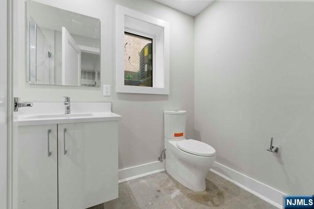 211 Warwick Avenue, Unit 1 Fort Lee, NJ 07024 - Photo 36 of 43 a bathroom with a toilet sink and mirror