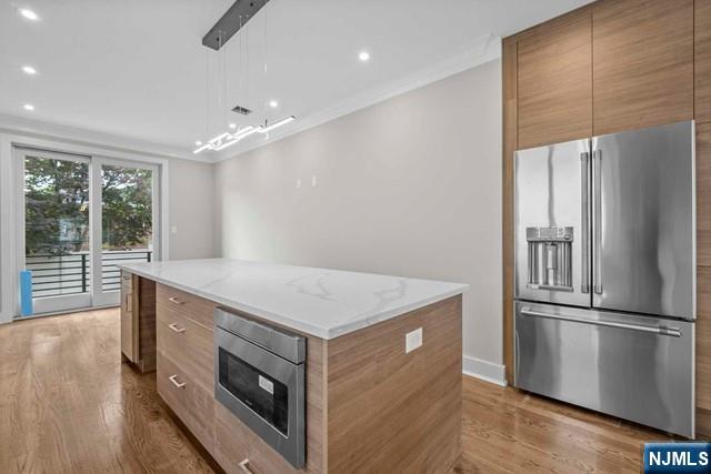 211 Warwick Avenue, Unit 1 Fort Lee, NJ 07024 - Photo 5 of 43 a kitchen with a stove a refrigerator and a sink
