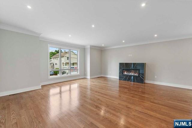 211 Warwick Avenue, Unit 1 Fort Lee, NJ 07024 - Photo 7 of 43 a view of an empty room with wooden floor and a window