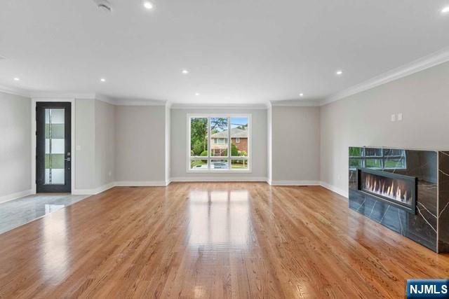 211 Warwick Avenue, Unit 1 Fort Lee, NJ 07024 - Photo 8 of 43 a view of an empty room with wooden floor and a window