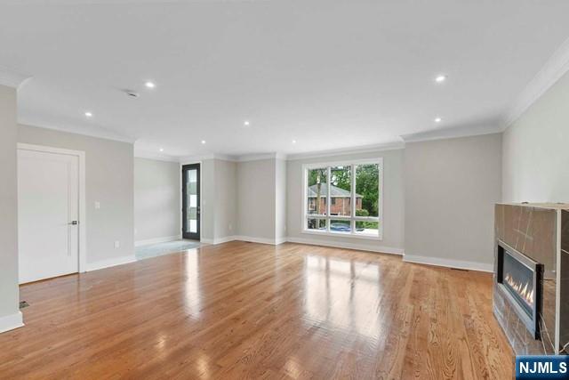 211 Warwick Avenue, Unit 1 Fort Lee, NJ 07024 - Photo 9 of 43 a view of an empty room with wooden floor and a window